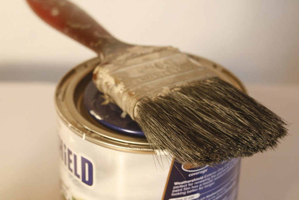 Photograph of a paintbrush on top of a paint can.